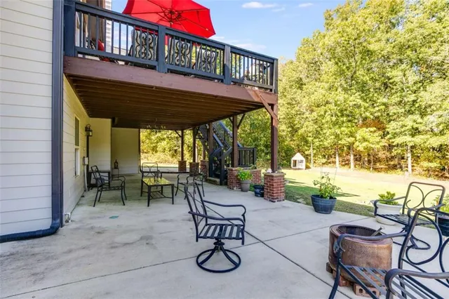 a view of a chairs and table in backyard