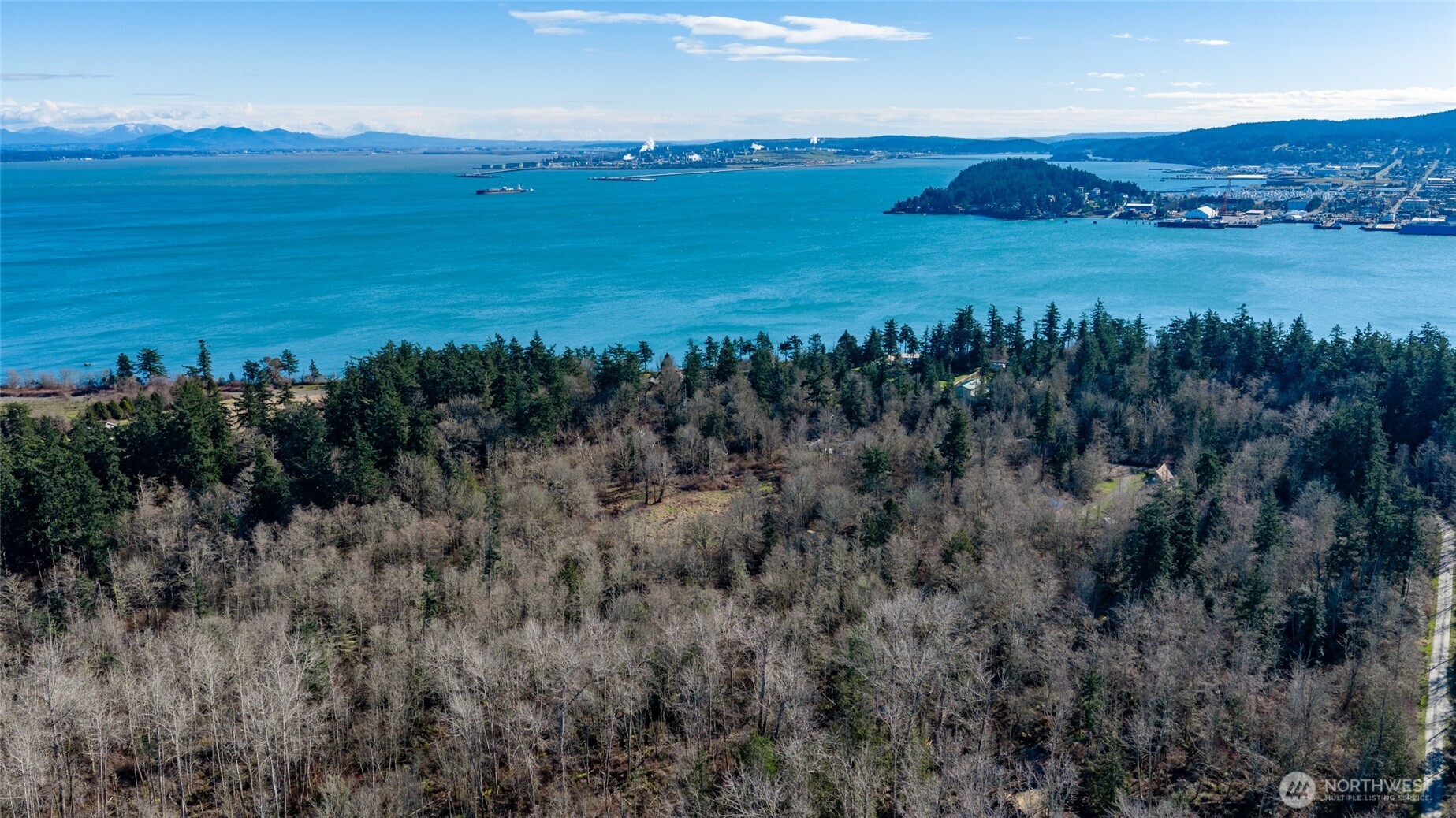6117 South Shore Road Anacortes, WA 98221 - Photo 4 of 7 a view of a lake with a city
