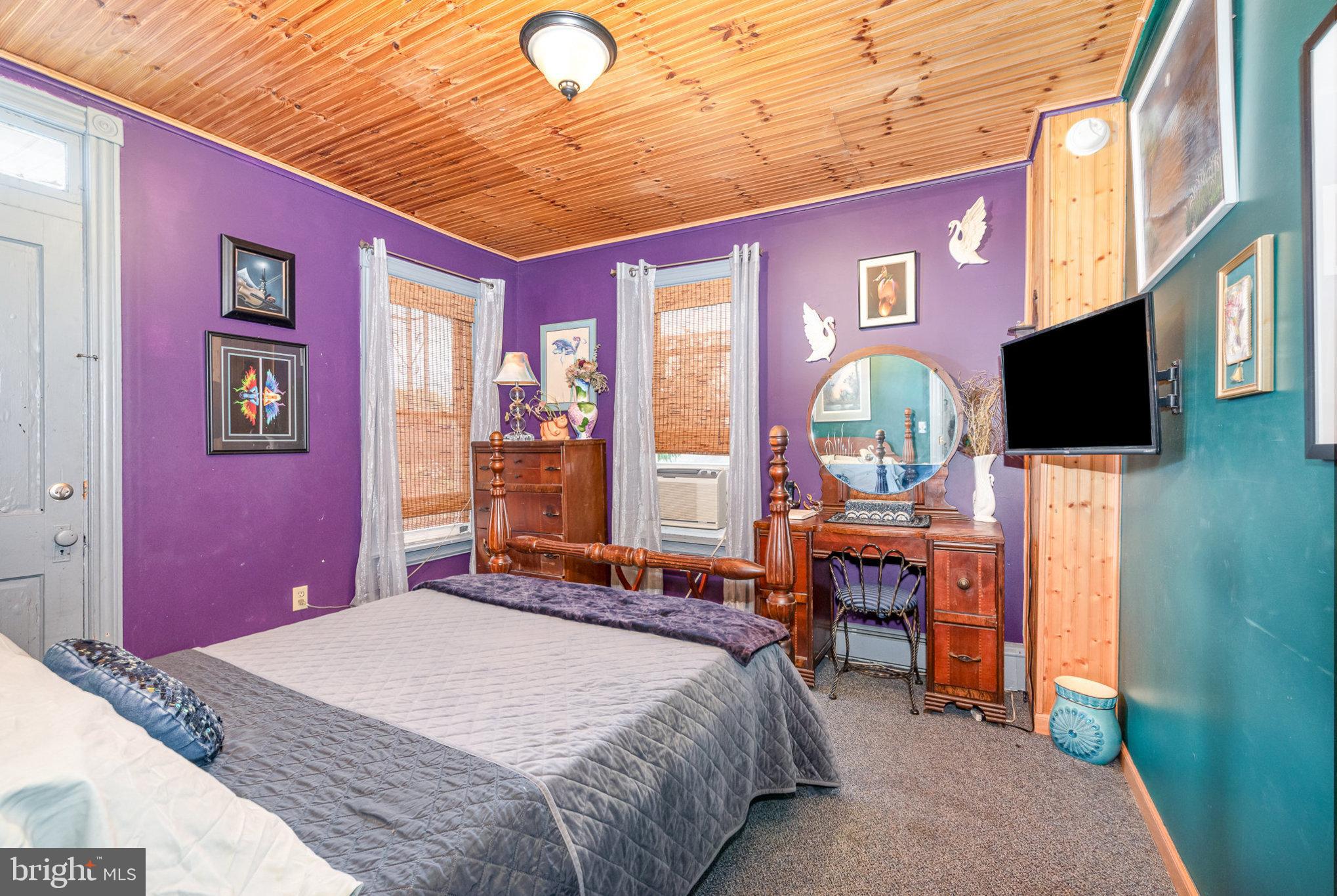 135 Lucknow Road Harrisburg, PA 17110 - Photo 16 of 27 a bedroom with a bed dresser and a flat screen tv