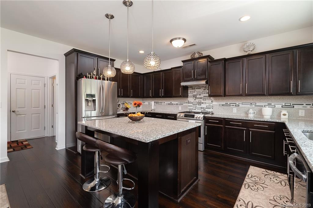 290 Fischer Road Fort Mill, SC 29715 - Photo 13 of 35 a kitchen with kitchen island granite countertop a sink appliances and cabinets