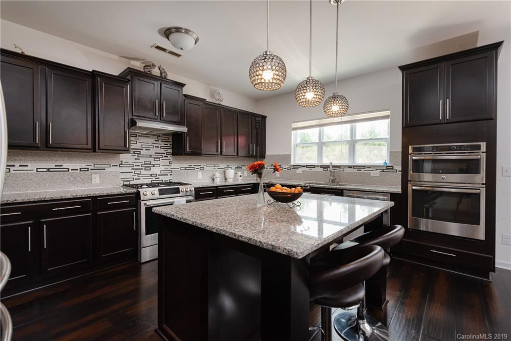 290 Fischer Road Fort Mill, SC 29715 - Photo 14 of 35 a kitchen with kitchen island granite countertop a sink cabinets and stainless steel appliances