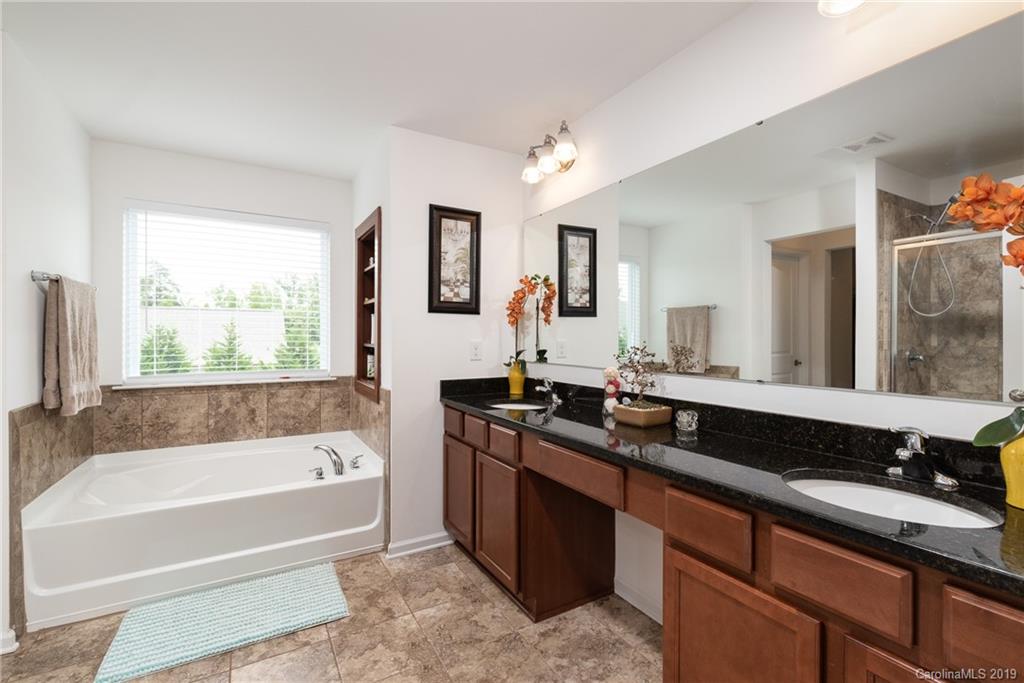290 Fischer Road Fort Mill, SC 29715 - Photo 20 of 35 a bath room with a sink a mirror and a bathtub