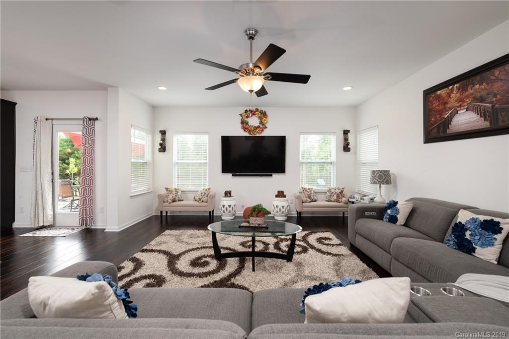 290 Fischer Road Fort Mill, SC 29715 - Photo 9 of 35 a living room with furniture a flat screen tv and a chandelier