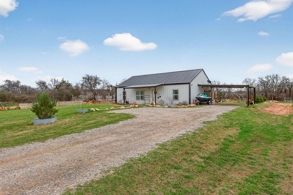 a front view of house with yard and green space