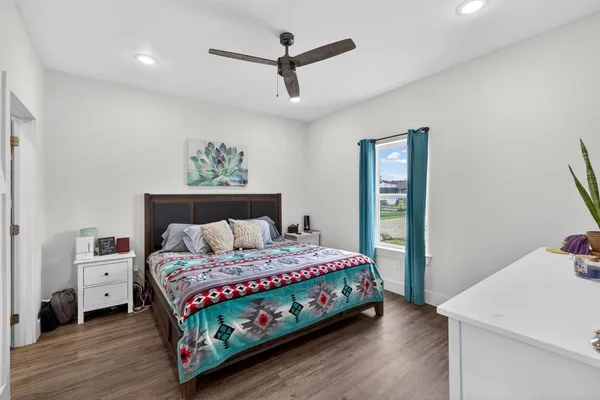 a bedroom with a bed and a refrigerator