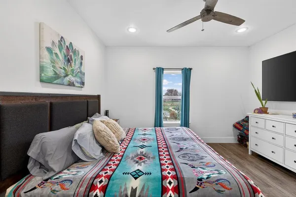 a bedroom with a bed and a window