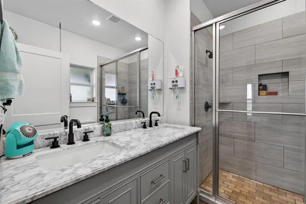 a bathroom with a sink a toilet and a mirror