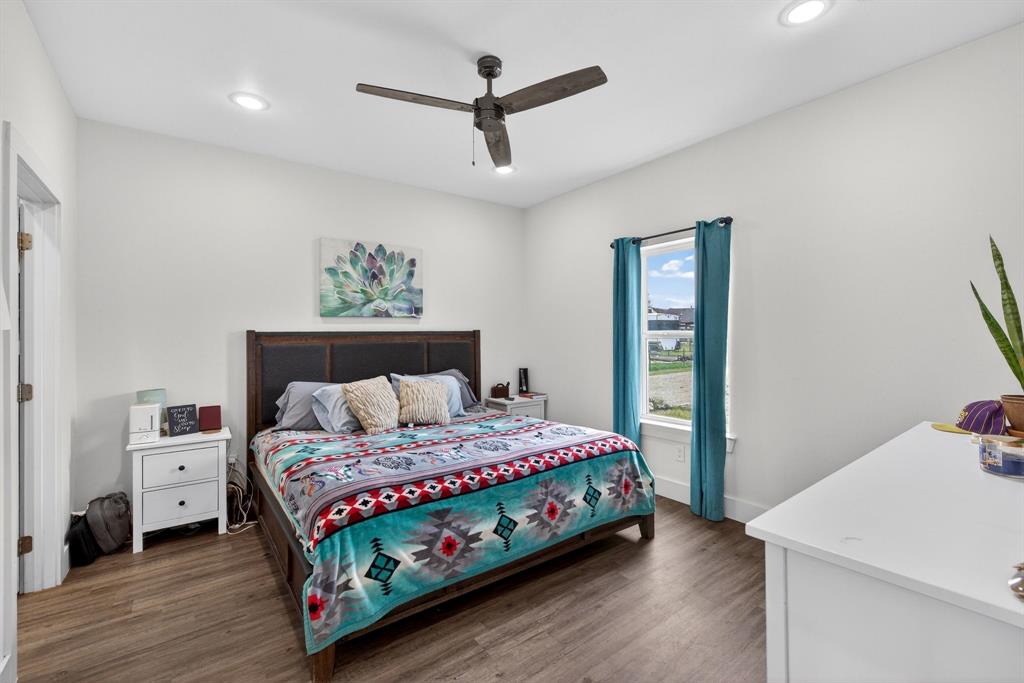 2225 West J E Woody Road Springtown, TX 76082 - Photo 14 of 29 a bedroom with a bed and a dresser