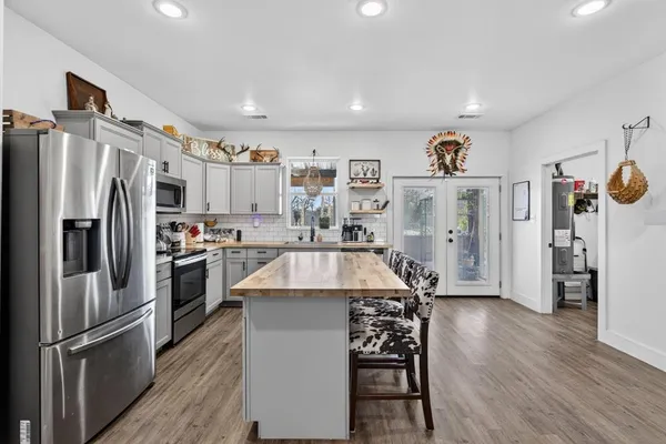 an aerial view of residential houses with outdoor space and river