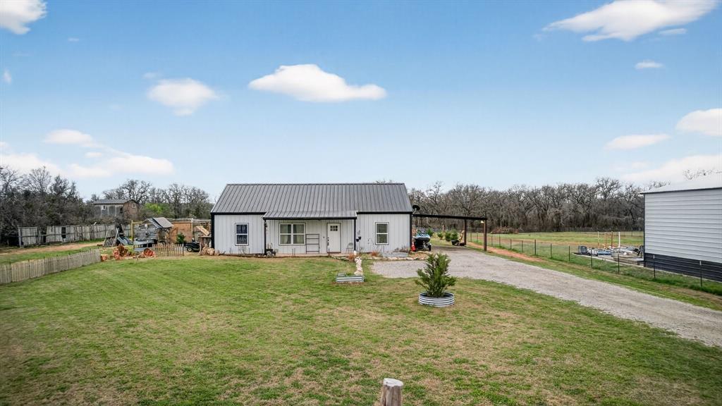 2225 West J E Woody Road Springtown, TX 76082 - Photo 27 of 29 a house view with swimming pool and yard