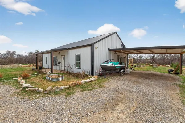 a view of a patio with a table chairs and a backyard