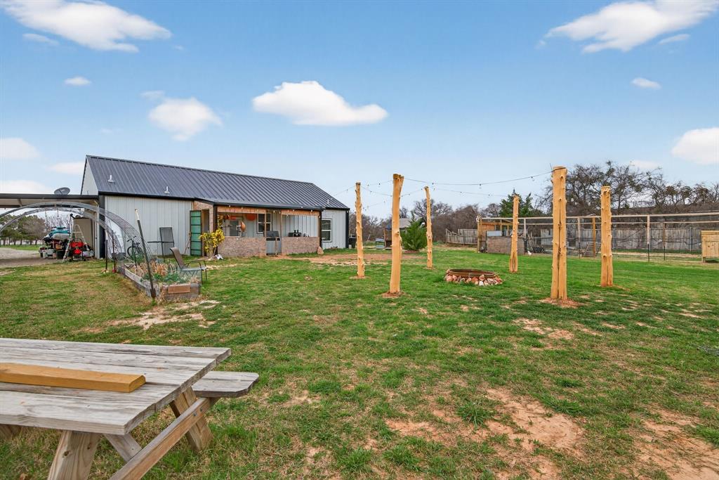 2225 West J E Woody Road Springtown, TX 76082 - Photo 9 of 29 a view of a house with a yard