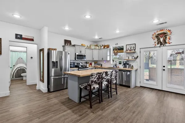 a bathroom with a granite countertop sink a mirror and shower