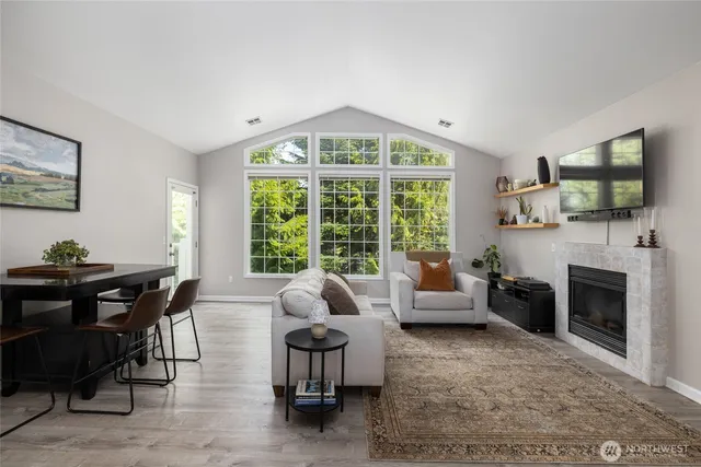 a living room with furniture a fireplace and a flat screen tv