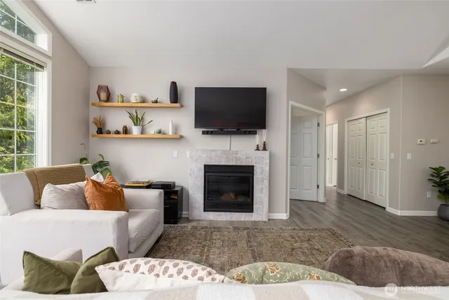 a living room with furniture a flat screen tv and a fireplace