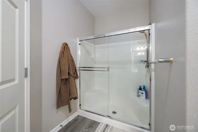 a bathroom with a shower and a glass door
