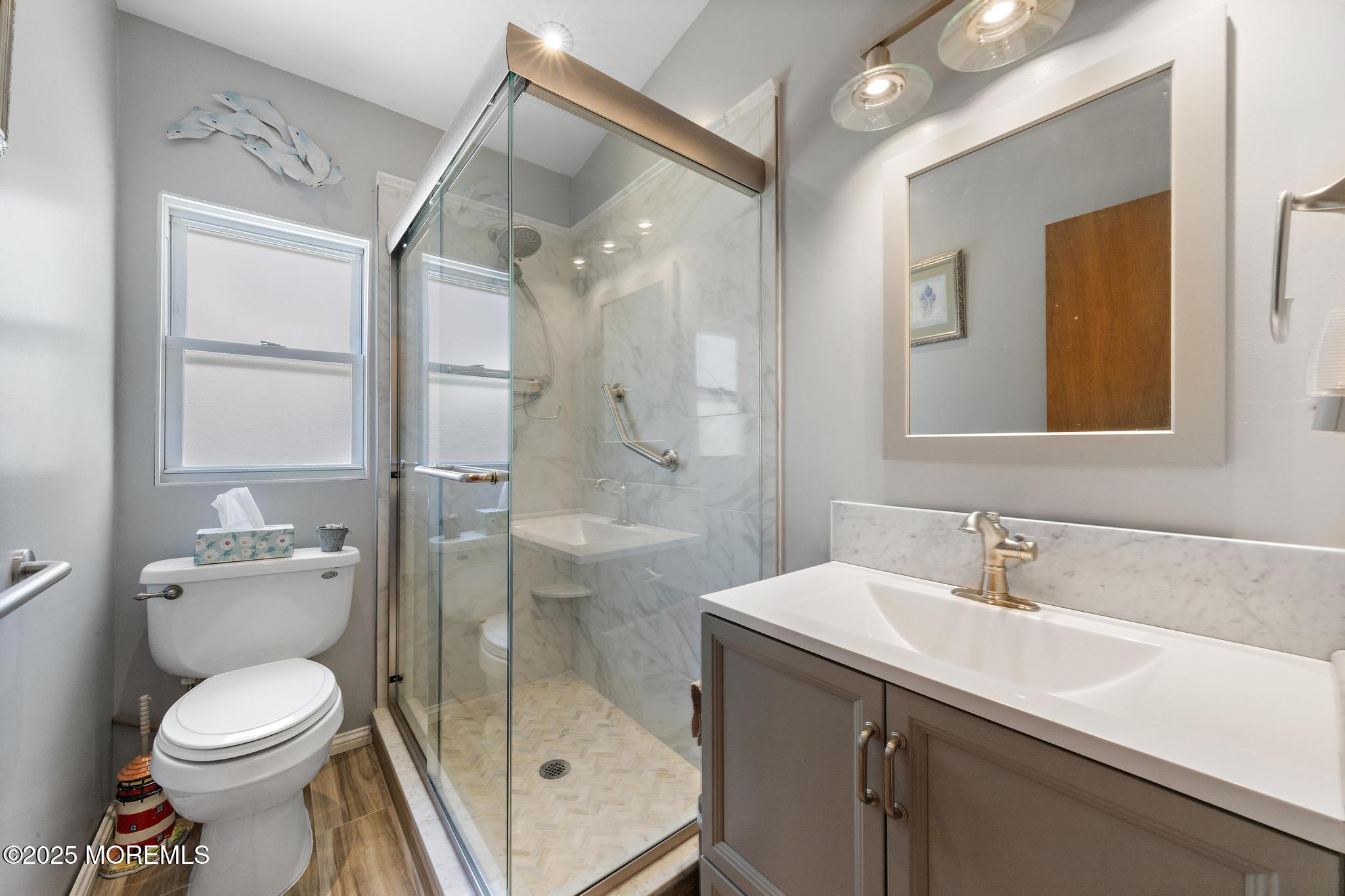 68 Patrick Drive Beach Haven West, NJ 08050 - Photo 12 of 16 a bathroom with a sink a toilet and shower