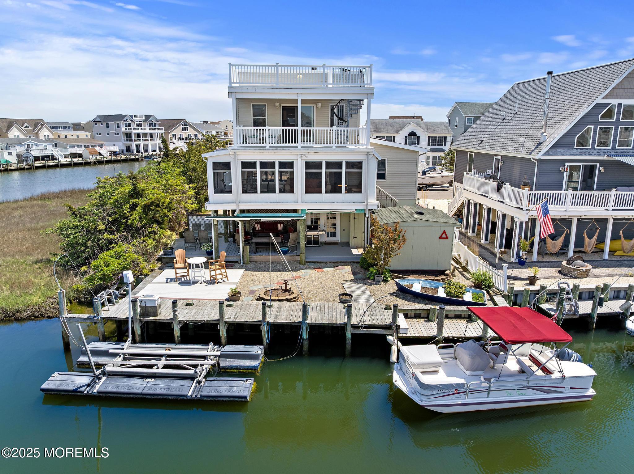 68 Patrick Drive Beach Haven West, NJ 08050 - Photo 14 of 16 a aerial view of a house with swimming pool table and chairs