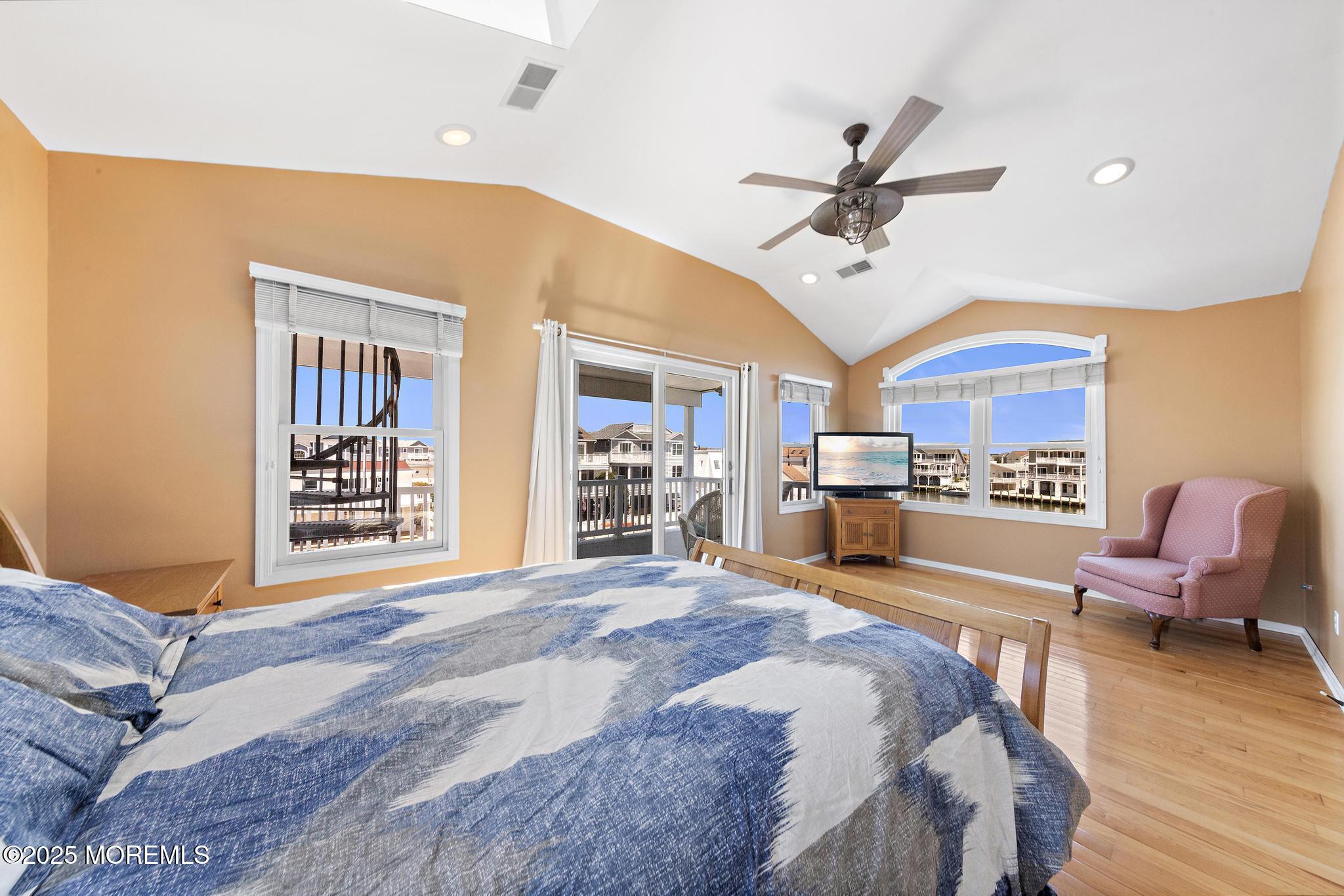 68 Patrick Drive Beach Haven West, NJ 08050 - Photo 6 of 16 a spacious bedroom with a bed a chandelier and dresser