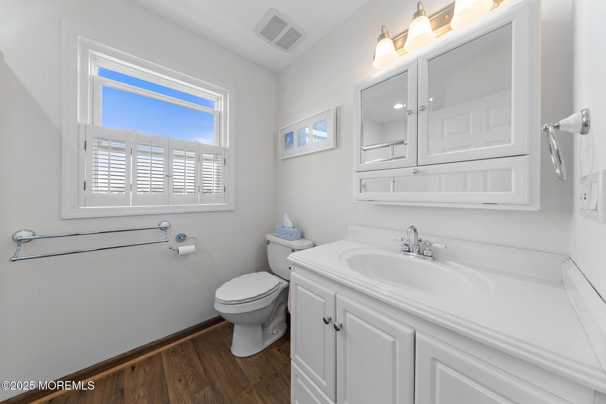 68 Patrick Drive Beach Haven West, NJ 08050 - Photo 9 of 16 a bathroom with a sink a toilet and a window