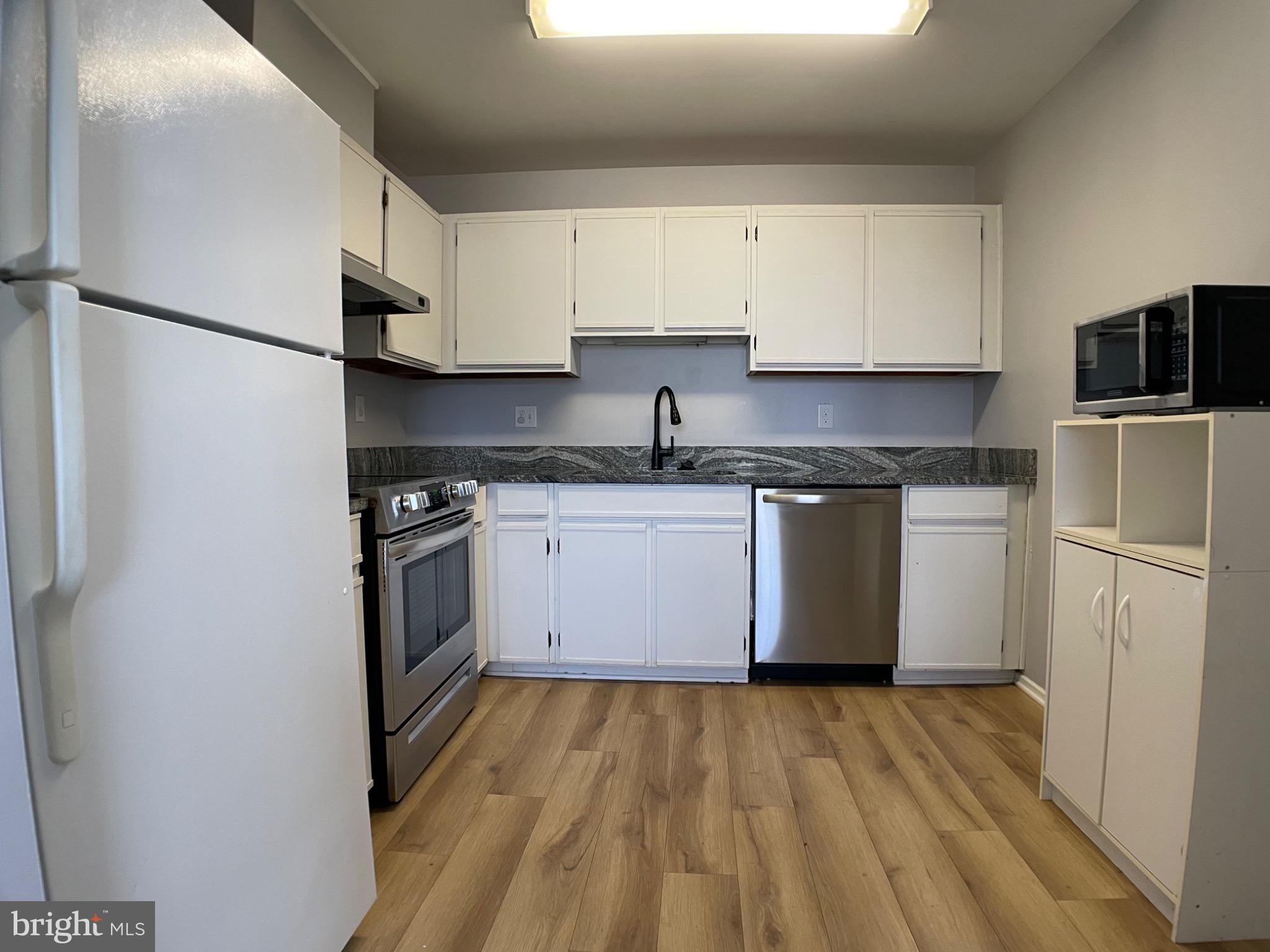 a kitchen with a sink stove and refrigerator