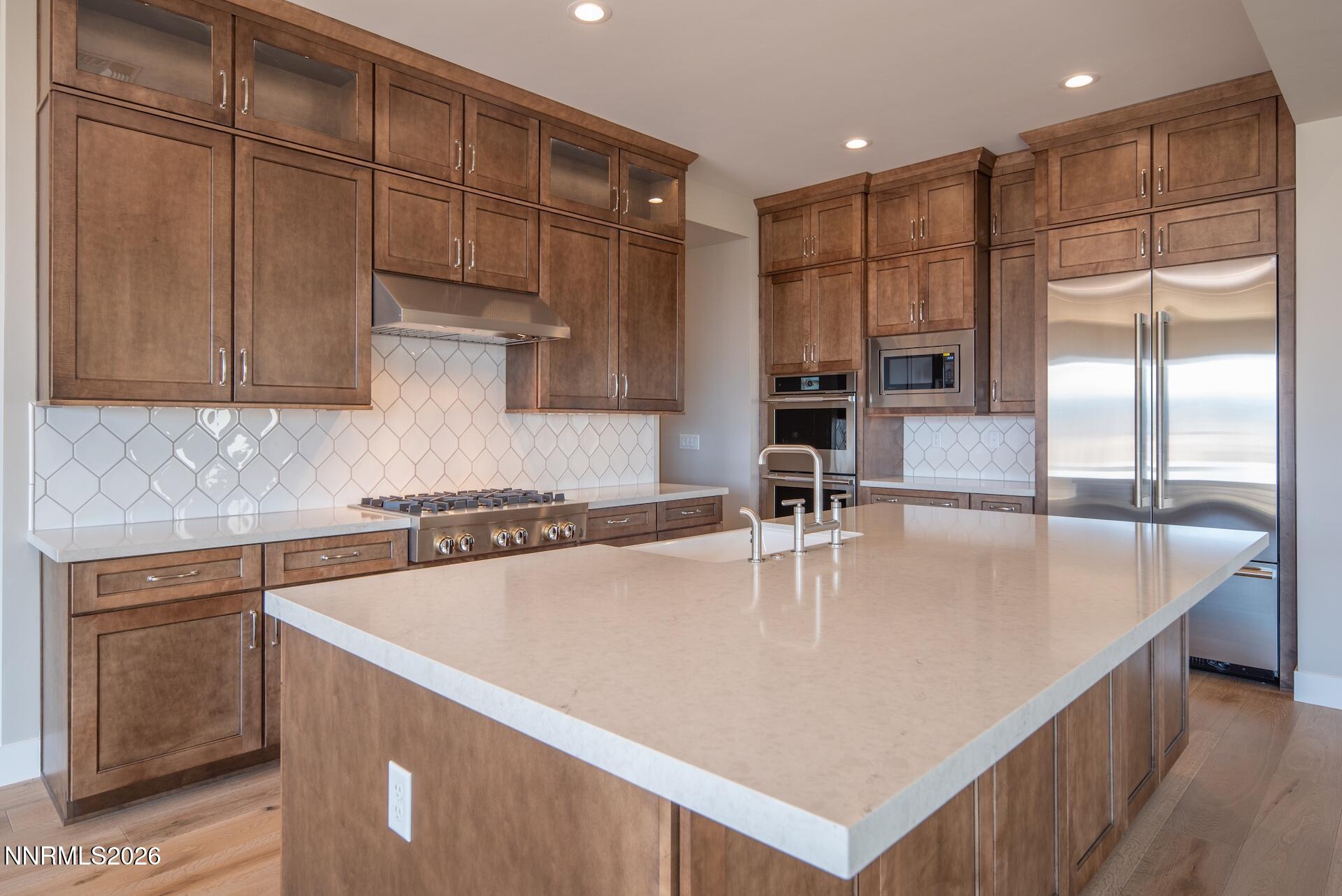 2241 Cold Creek Trail Reno, NV 89523 - Photo 12 of 40 a large kitchen with kitchen island a large counter top stainless steel appliances and cabinets