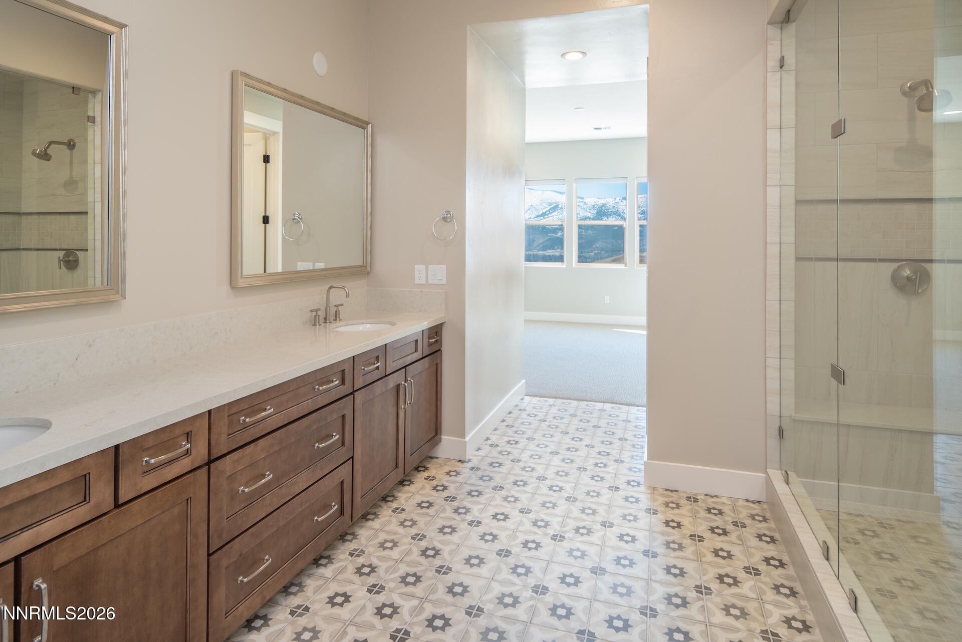 2241 Cold Creek Trail Reno, NV 89523 - Photo 19 of 40 a bathroom with a sink a toilet a mirror and shower