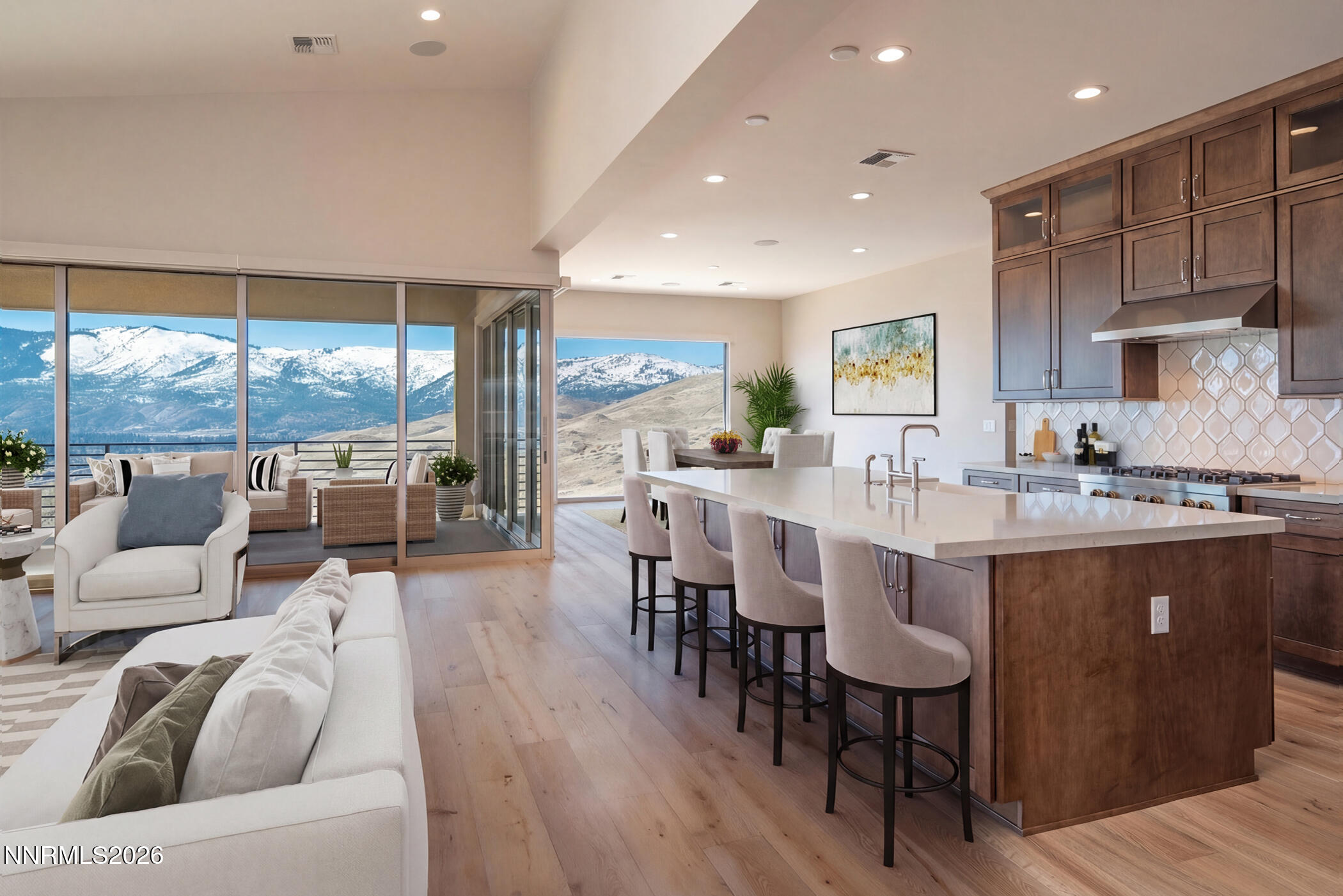2241 Cold Creek Trail Reno, NV 89523 - Photo 2 of 40 a kitchen with stainless steel appliances granite countertop a stove a refrigerator a sink a dining table and chairs with wooden floor
