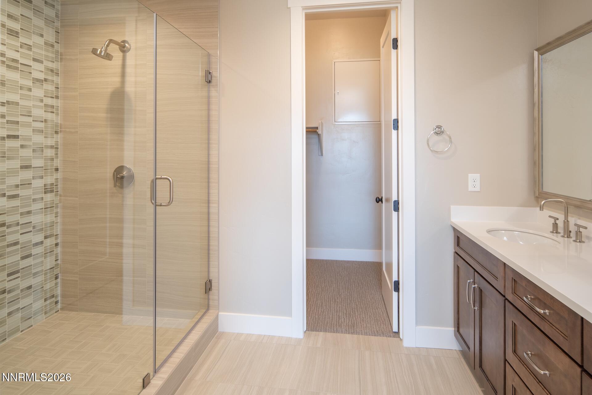 2241 Cold Creek Trail Reno, NV 89523 - Photo 22 of 40 a bathroom with a shower sink and mirror