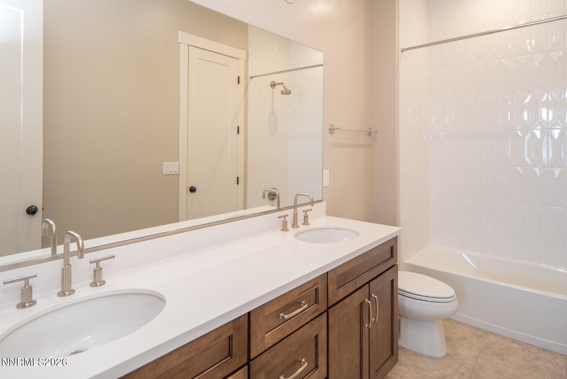 2241 Cold Creek Trail Reno, NV 89523 - Photo 25 of 40 a bathroom with a granite countertop sink toilet a large mirror and shower