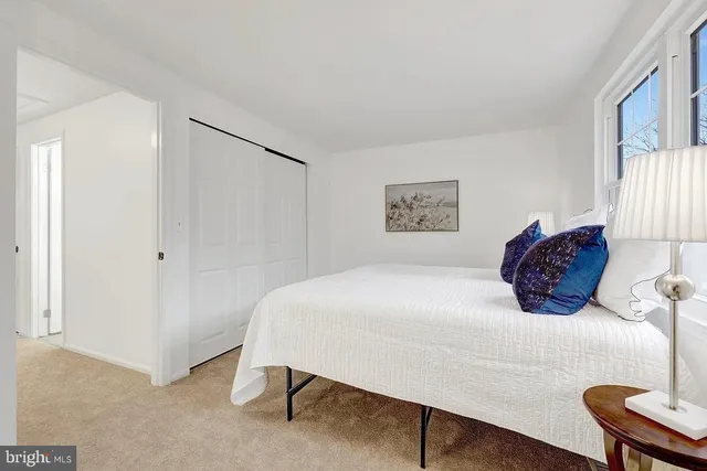 a bedroom with a bed and a chair