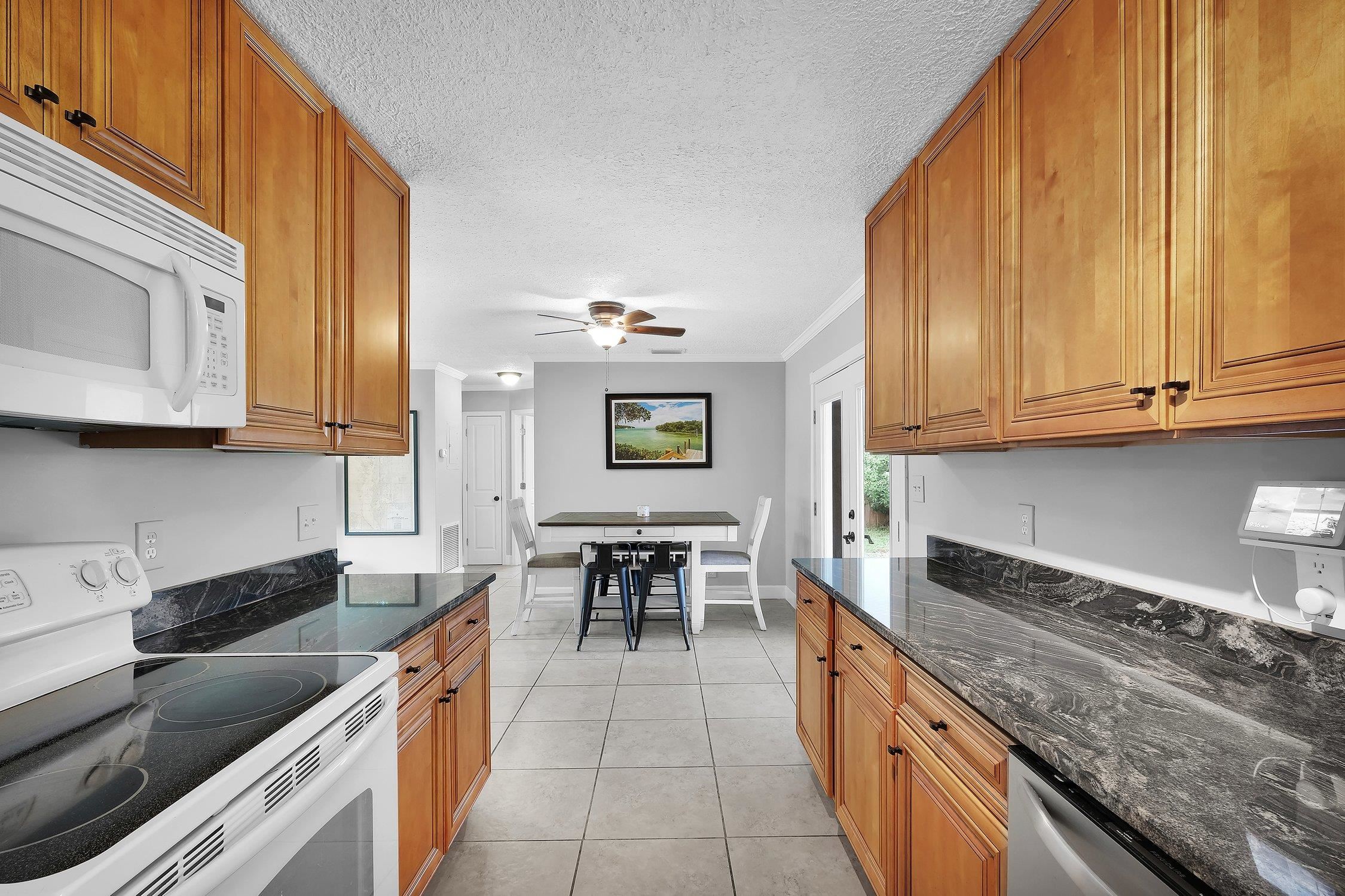 141 Argonaut Road St. Augustine, FL 32086 - Photo 14 of 27 a kitchen with stainless steel appliances granite countertop a sink and cabinets