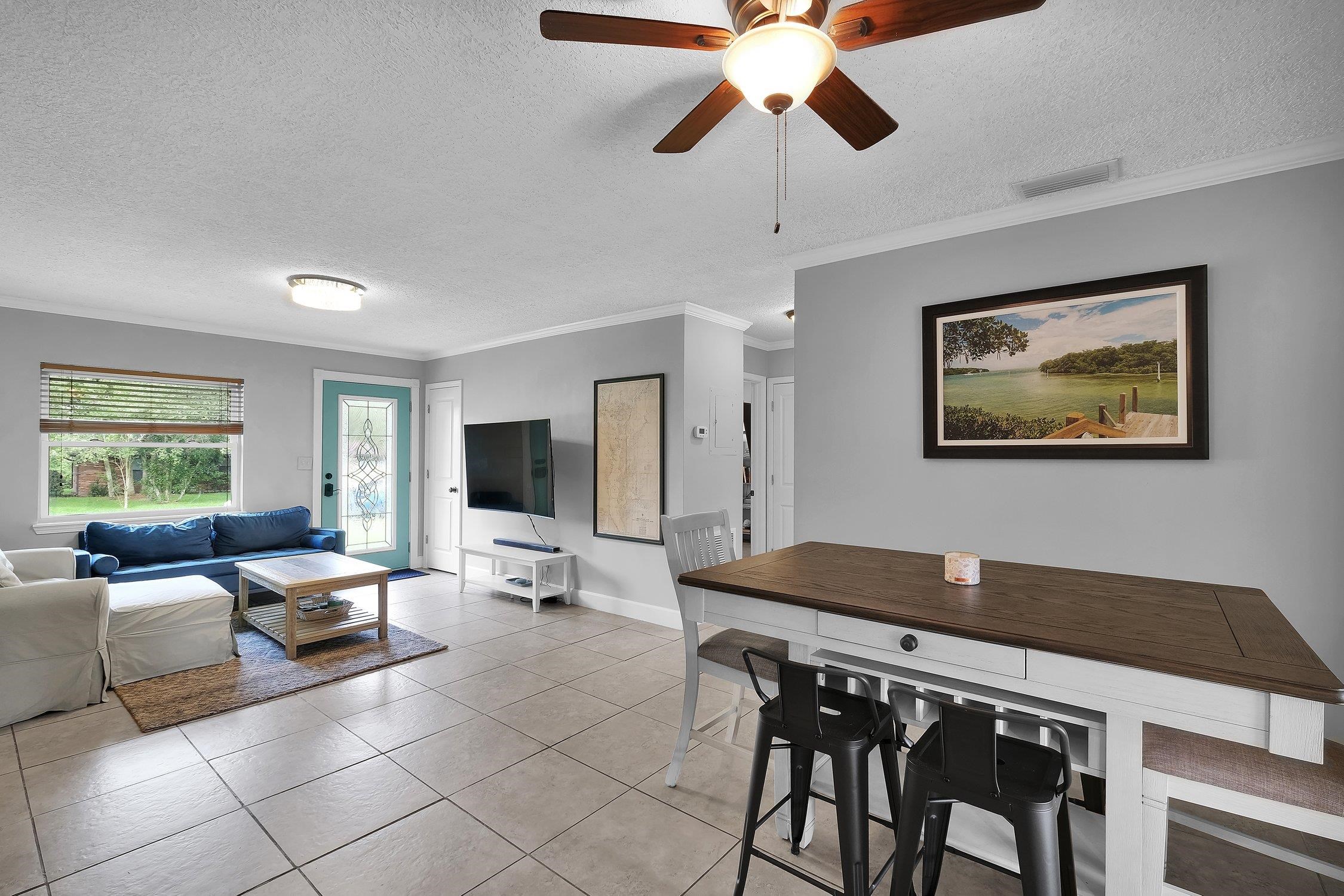 141 Argonaut Road St. Augustine, FL 32086 - Photo 15 of 27 a living room with furniture two window and a flat screen tv
