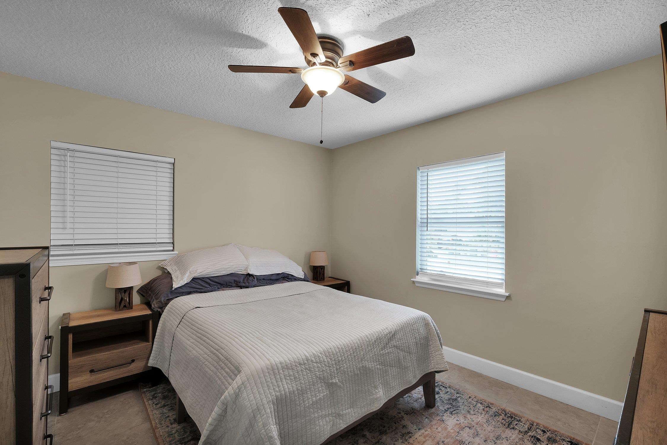 141 Argonaut Road St. Augustine, FL 32086 - Photo 16 of 27 a bedroom with a large bed and a window
