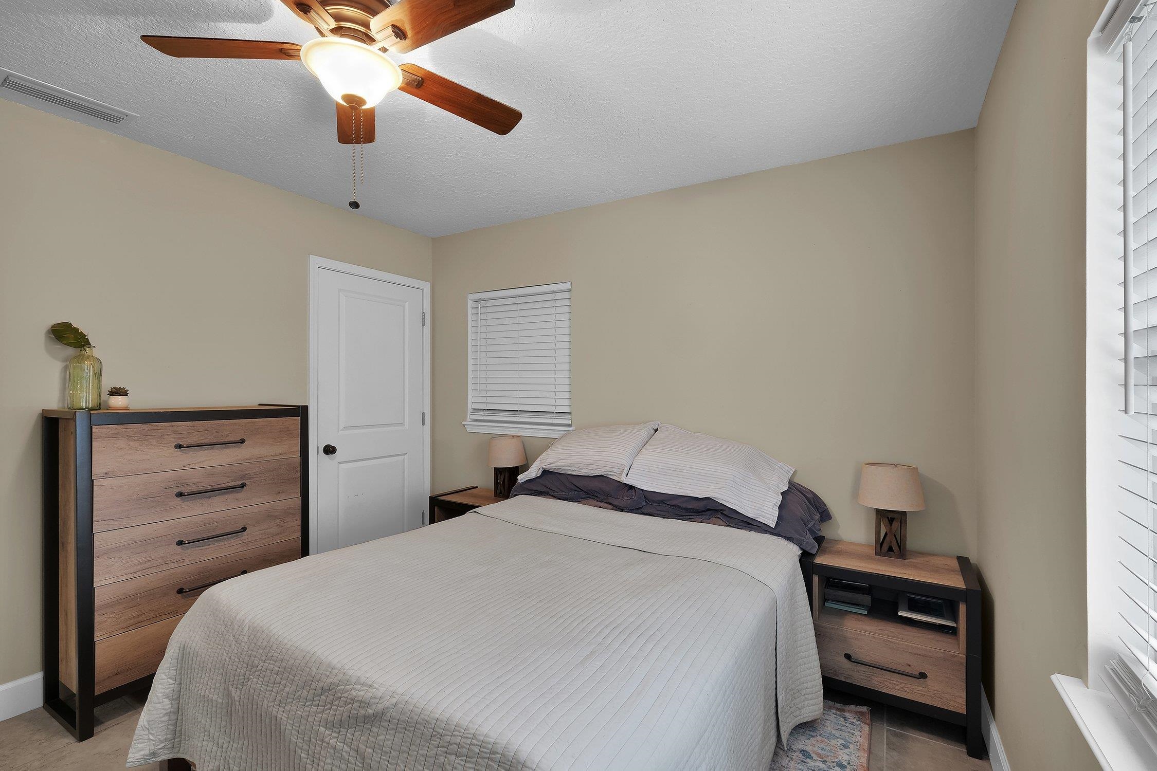 141 Argonaut Road St. Augustine, FL 32086 - Photo 17 of 27 a bedroom with a bed and a chandelier