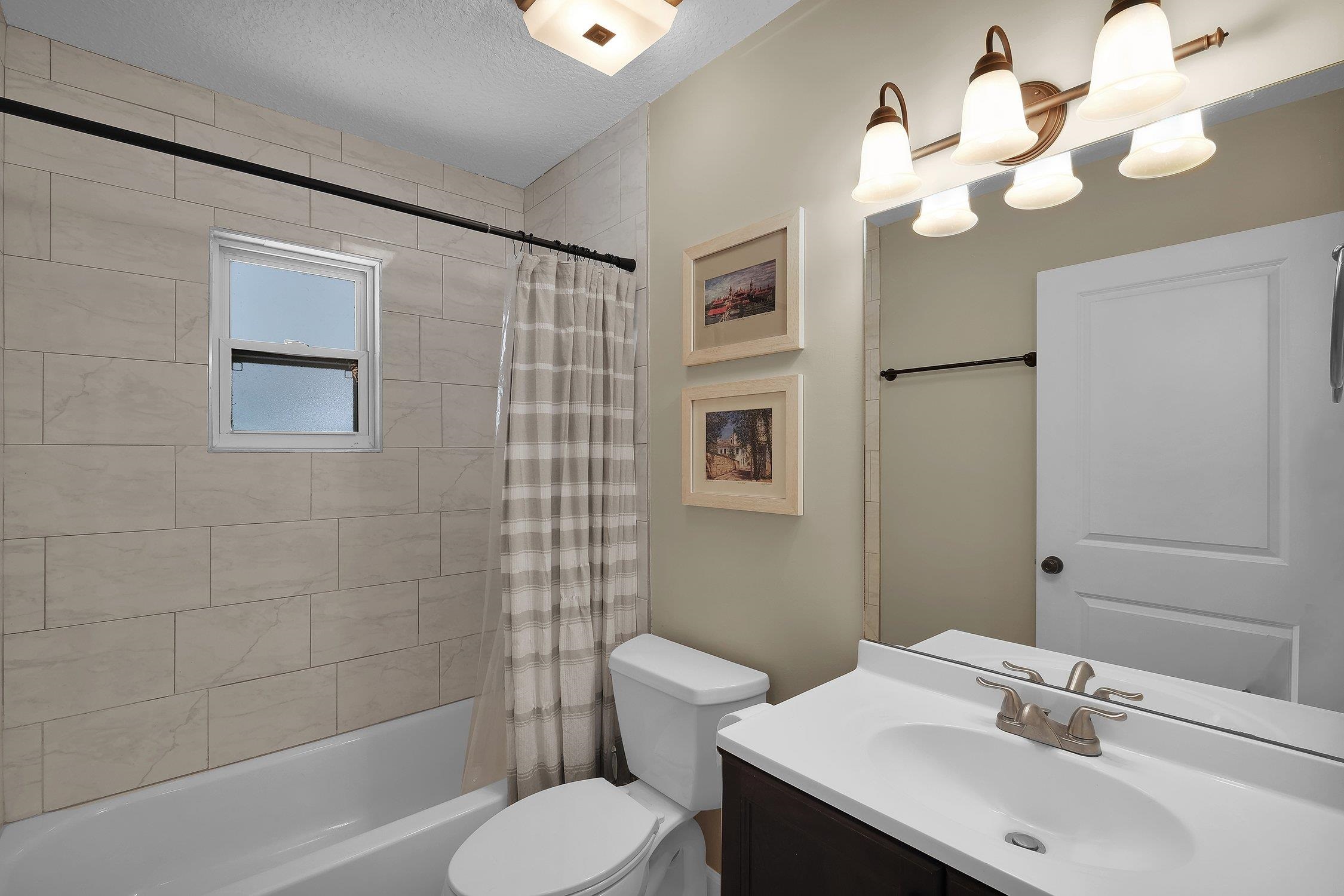 141 Argonaut Road St. Augustine, FL 32086 - Photo 21 of 27 a bathroom with a sink a toilet and shower