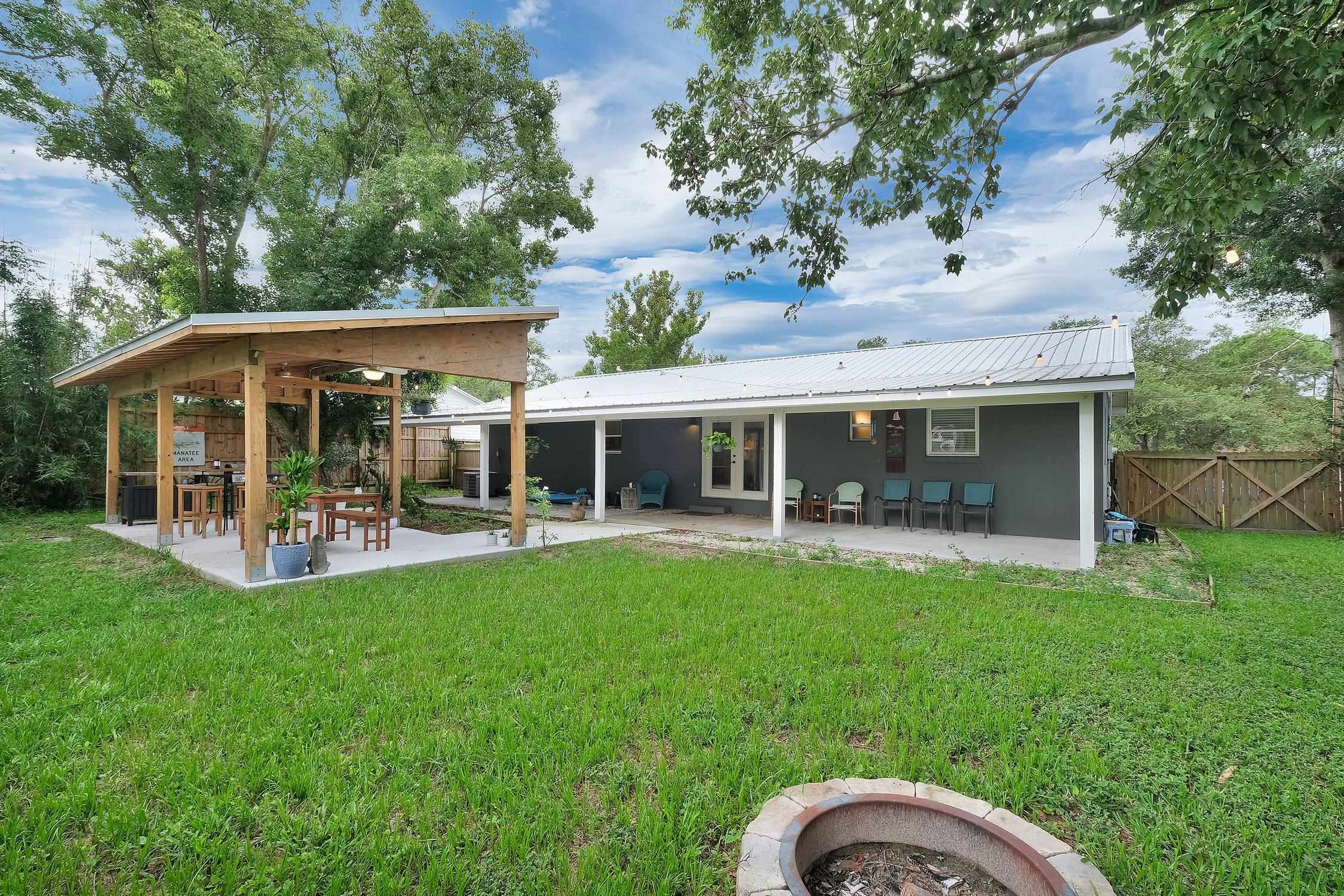 141 Argonaut Road St. Augustine, FL 32086 - Photo 25 of 27 a view of a house with a backyard and a patio