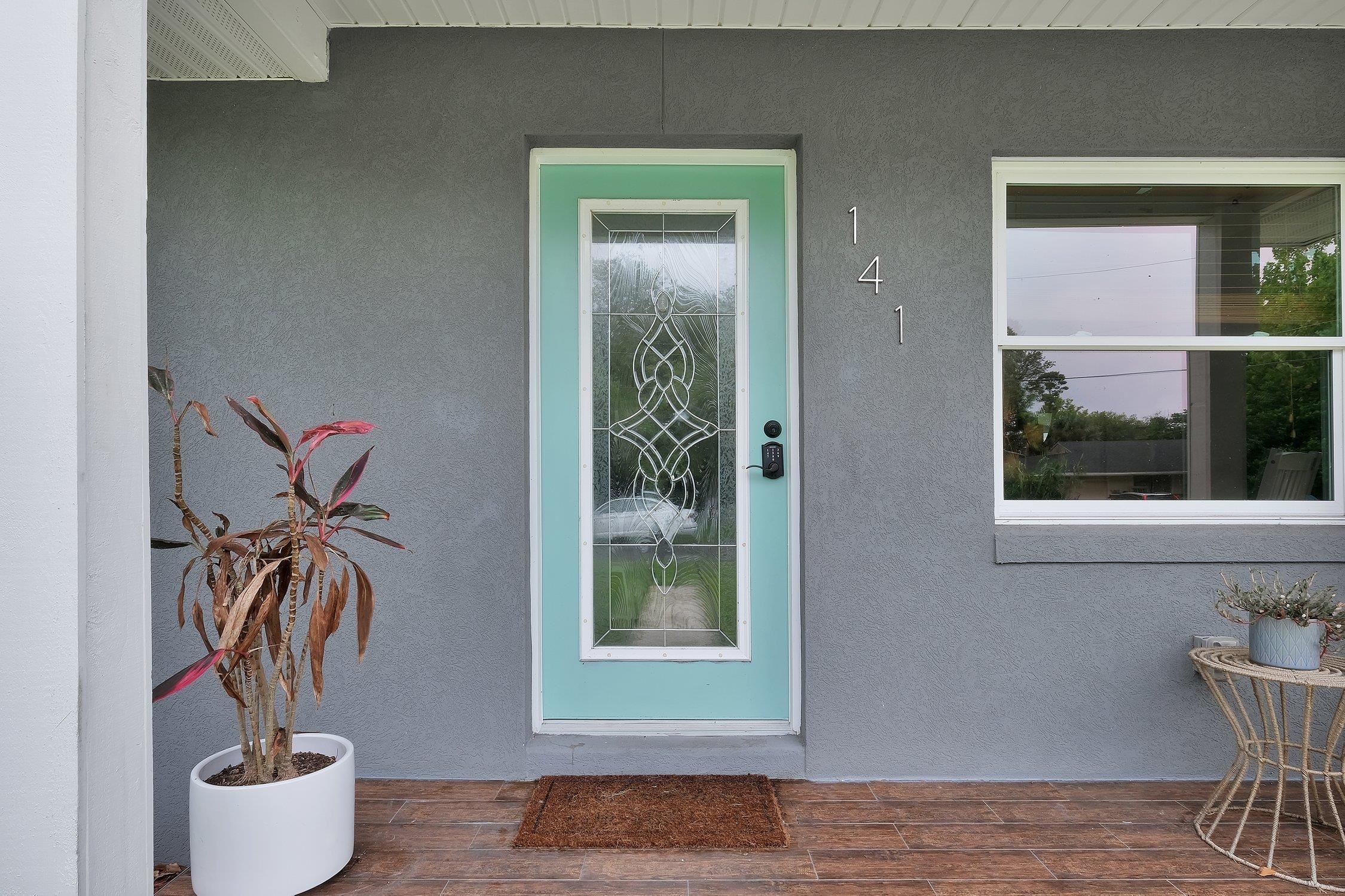 141 Argonaut Road St. Augustine, FL 32086 - Photo 5 of 27 a vase of flowers sitting on a table next to a window