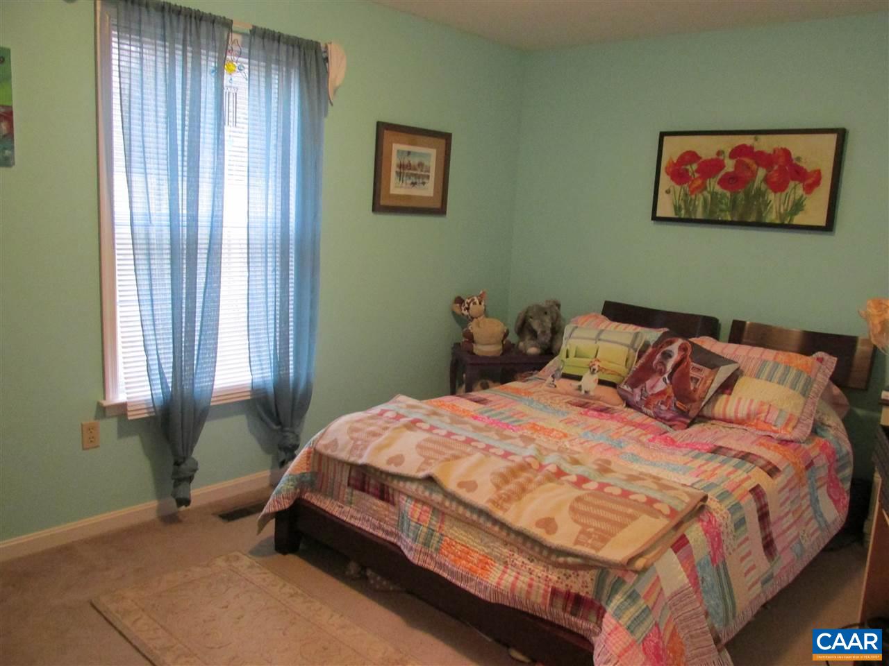 688 Carnation Road Ruckersville, VA 22968 - Photo 13 of 25 a bedroom with a bed and a painting on the wall