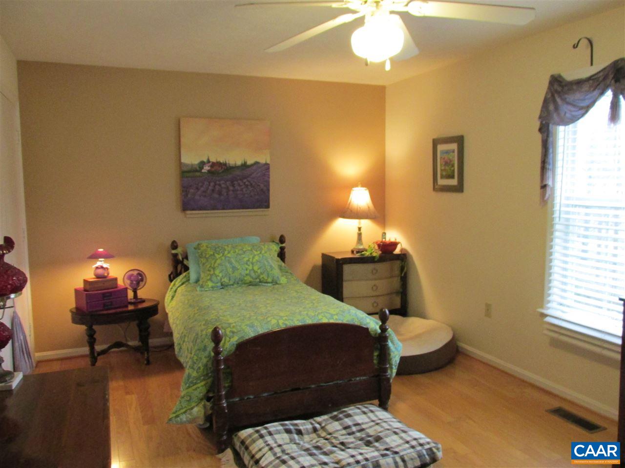 688 Carnation Road Ruckersville, VA 22968 - Photo 10 of 25 a bedroom with a bed and a chandelier