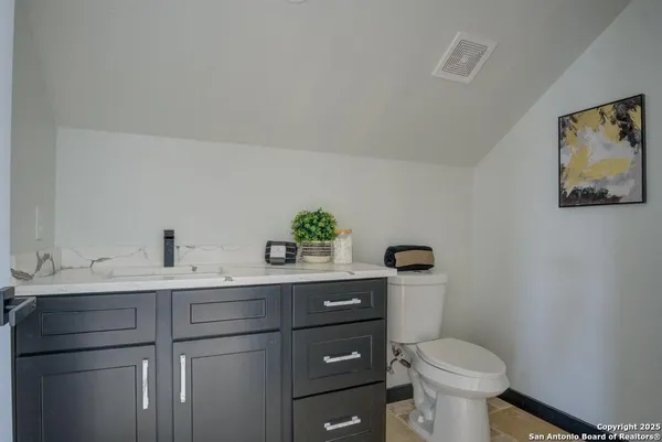a bathroom with a toilet sink and mirror