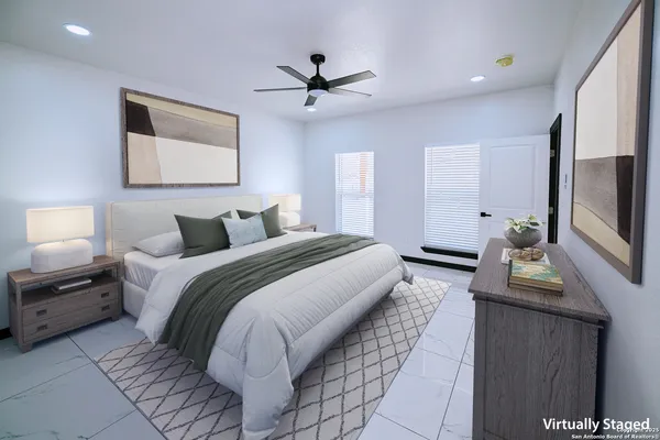 a bedroom with a large bed a chandelier and flat screen tv