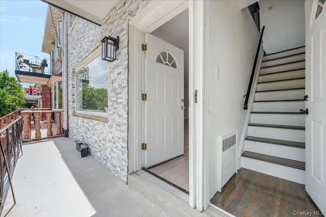 a view of a hallway with windows and stairs