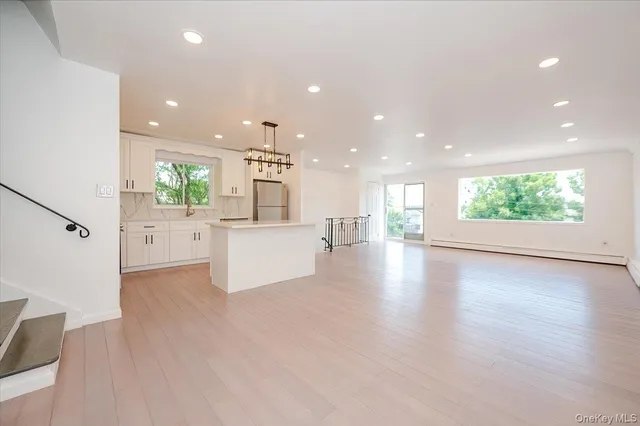 a view of a kitchen and an entryway of a kitchen