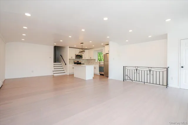 a view of kitchen with stainless steel appliances a refrigerator and a stove top oven