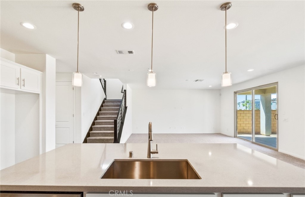 784 Sawgrass Street Perris, CA 92571 - Photo 12 of 46 a view of an kitchen with furniture and floor to ceiling window