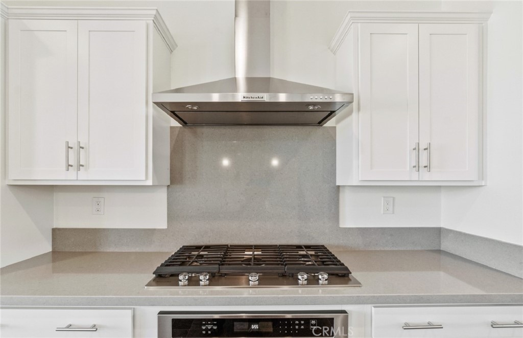 784 Sawgrass Street Perris, CA 92571 - Photo 13 of 46 a stove top oven sitting inside of a kitchen