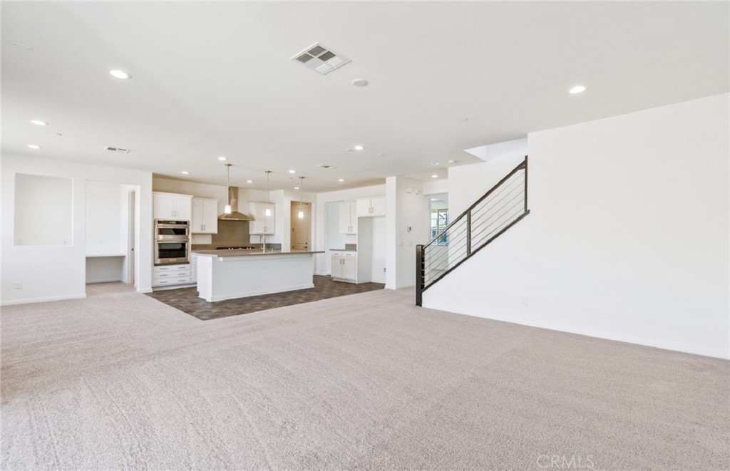 784 Sawgrass Street Perris, CA 92571 - Photo 19 of 46 a view of kitchen with refrigerator and white cabinets