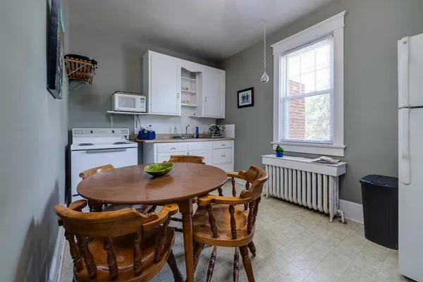 a dining room with furniture and window