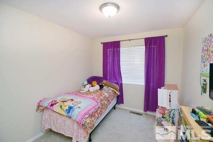 4755 Goodwin Road Sparks, NV 89436 - Photo 13 of 38 a bedroom with a bed and a window
